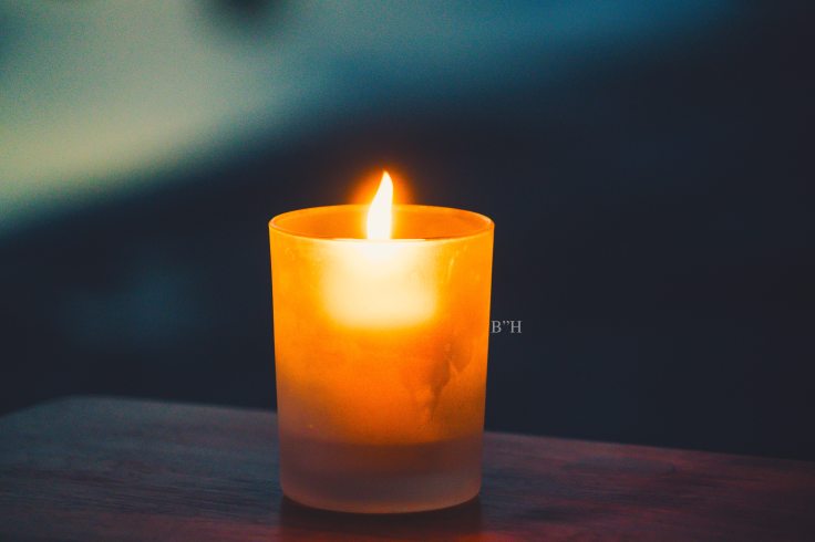 orange yarhzeit memorial candle flame remembering lost child