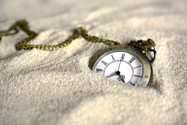 pocket watch in the sand, time stops for parents who grieve