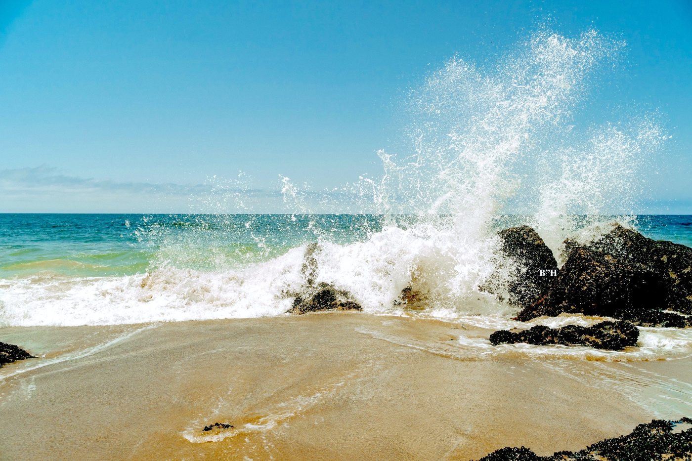 large ocean wave crashing on rocks, like grief and anger