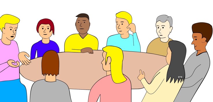 Group therapy with people sitting around a table