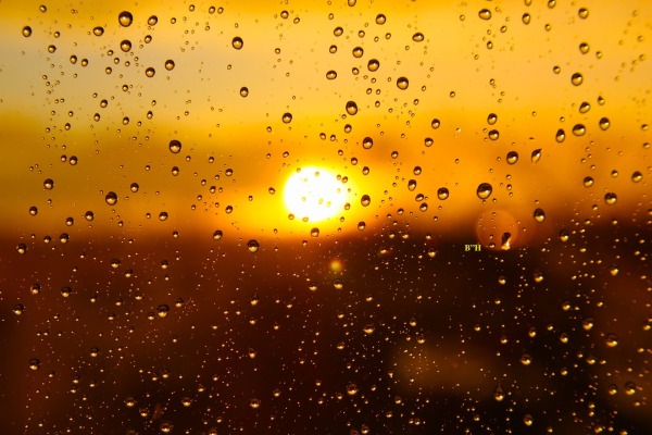sun shining through window with raindrops giving comfort and hope from grief