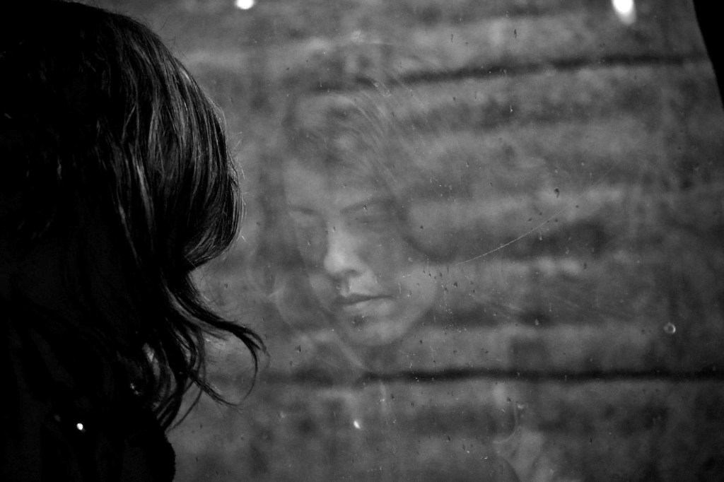 woman looking at her reflection