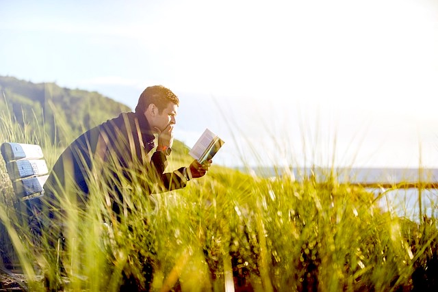 man reading books of poetry for comfort after loss