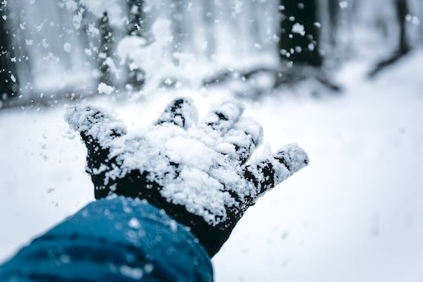 Snow silently falling on a person's hand. Thoughts on my child's yahrzeit.