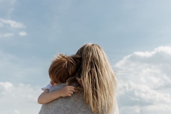 The Three Weeks: Why We Struggle to Mourn the Temple. Mom hugging small child. Child loss, getting our children back.